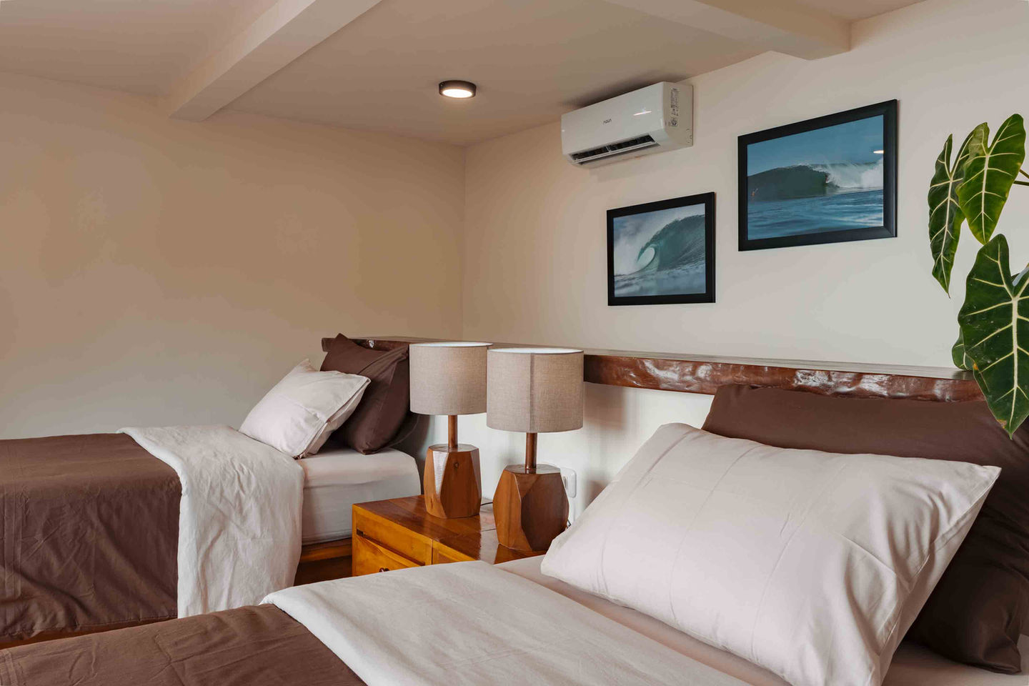 Twin-share bungalow interior with two beds at The Ujung Bocur Bungalows