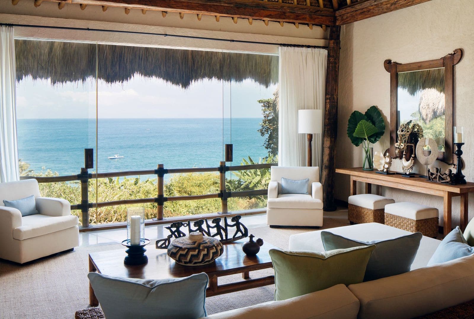 Open-air thatched living pavilion with ocean view and traditional Sumbanese décor
