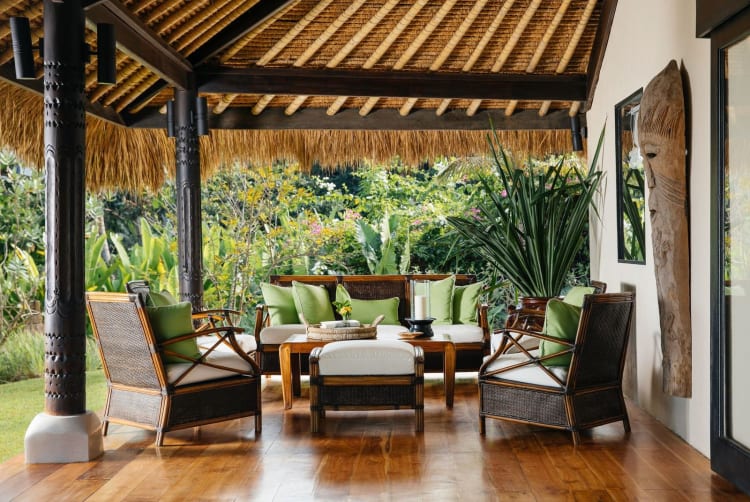 Shaded pavilion lounge under a thatched roof